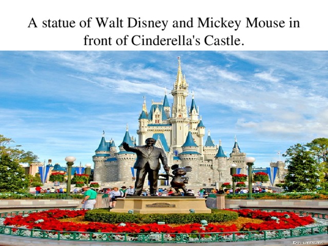 A statue of Walt Disney and Mickey Mouse in front of Cinderella's Castle . 
