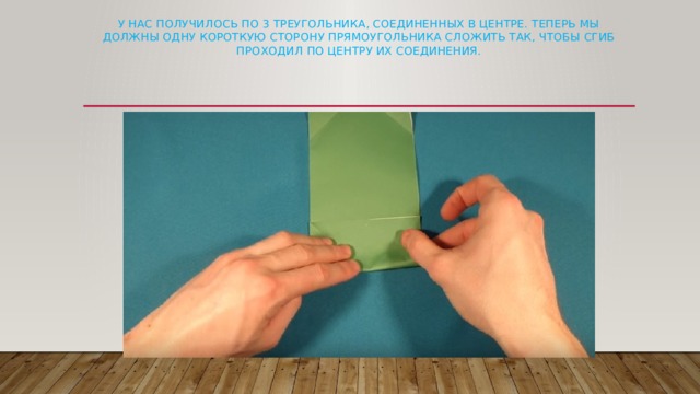 У нас получилось по 3 треугольника, соединенных в центре. Теперь мы должны одну короткую сторону прямоугольника сложить так, чтобы сгиб проходил по центру их соединения.   