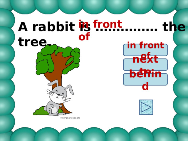 in front of A rabbit is …………… the tree. in front of next to behind 